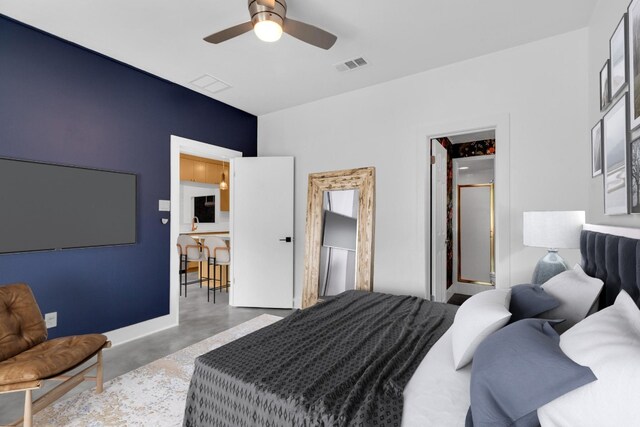 bedroom featuring a ceiling fan, visible vents, and concrete floors