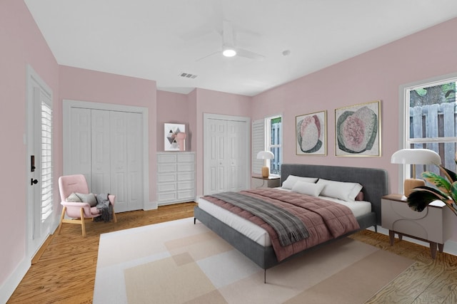 111 Crest View Dr, Lakeway, TX 78734 - bedroom with light wood-style flooring, multiple closets, baseboards, and ceiling fan