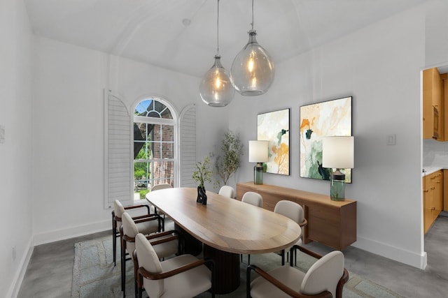dining area featuring baseboards and concrete floors