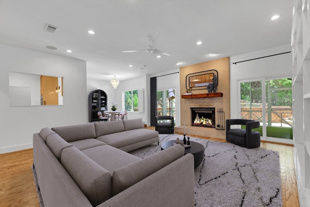 living room featuring visible vents, recessed lighting, a ceiling fan, and a fireplace