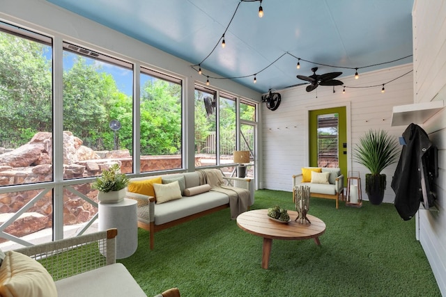 sunroom featuring an outdoor living space and ceiling fan
