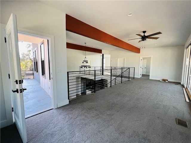 unfurnished living room with ceiling fan, visible vents, baseboards, and carpet