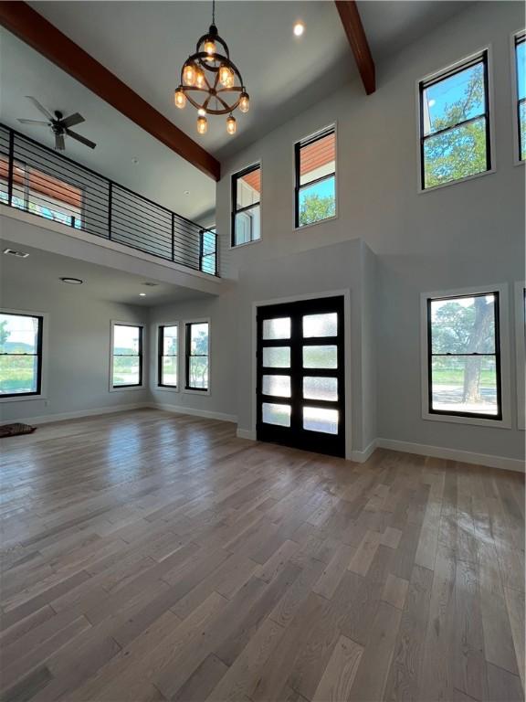 6308 Hudson Bend Rd, Austin, TX 78734 - entrance foyer with beamed ceiling, a high ceiling, wood finished floors, baseboards, and a ceiling fan