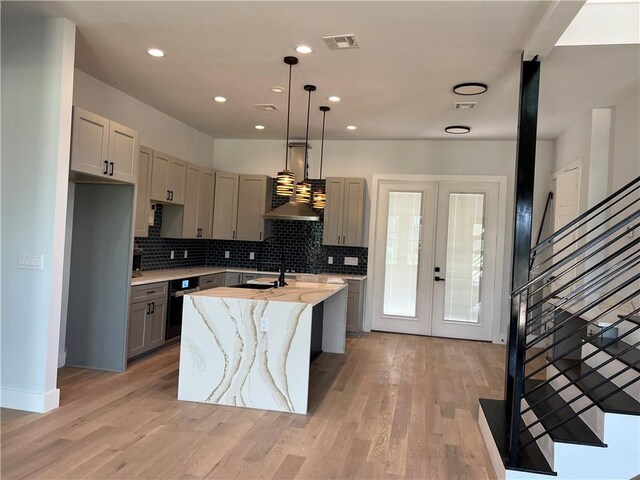 6308 Hudson Bend Rd, Austin, TX 78734 - kitchen with gray cabinets, backsplash, recessed lighting, light stone countertops, and an island with sink