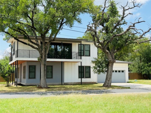 6308 Hudson Bend Rd, Austin, TX 78734 - view of front of property with a balcony, board and batten siding, a garage, and concrete driveway