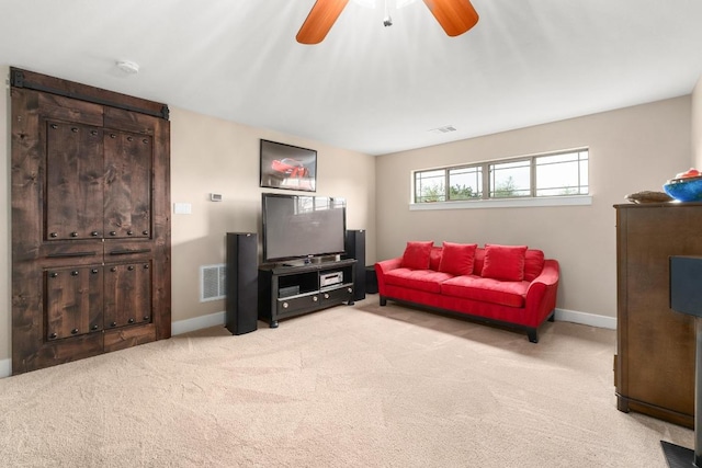 living room featuring baseboards, visible vents, ceiling fan, and light colored carpet