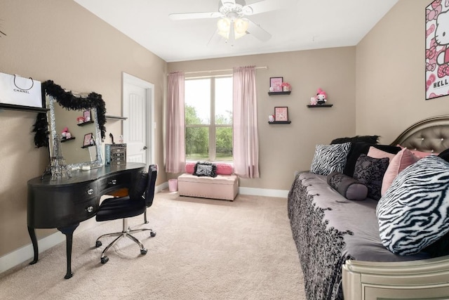 home office featuring baseboards, a ceiling fan, and light carpet