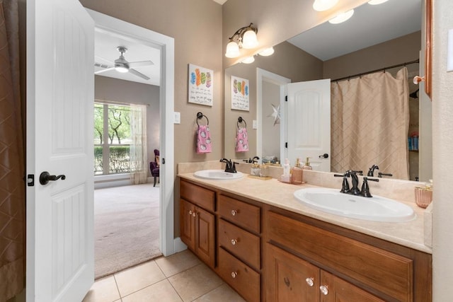 bathroom with a sink, tile patterned flooring, a ceiling fan, and double vanity