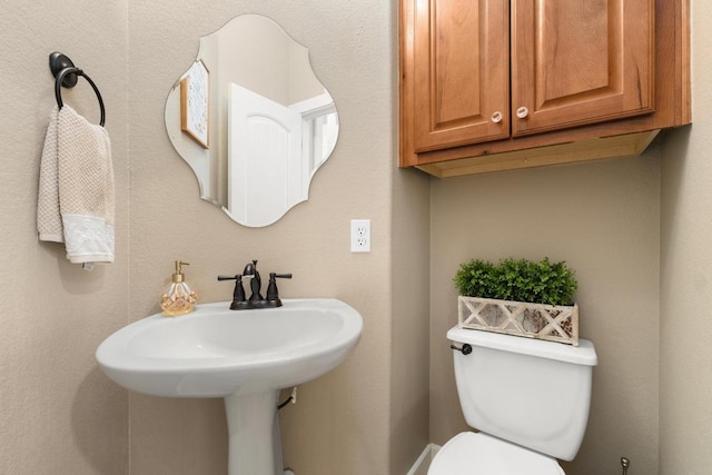 half bathroom featuring toilet