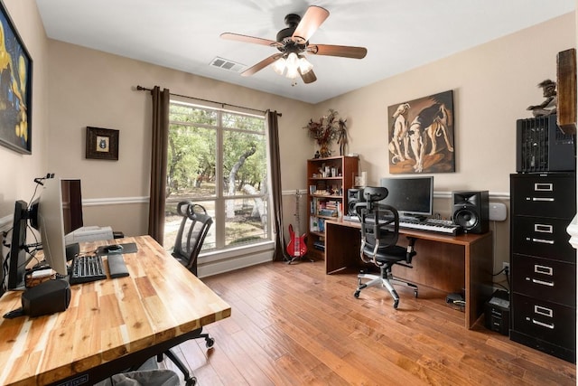 office area featuring ceiling fan, visible vents, and hardwood / wood-style floors