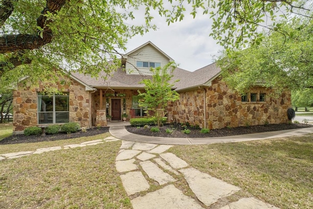 view of front of property with stone siding and a front lawn