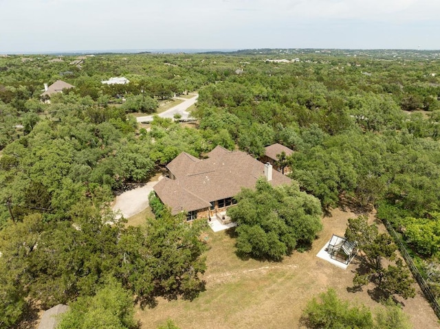birds eye view of property with a wooded view