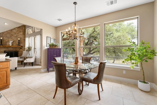 dining space with visible vents, a healthy amount of sunlight, and a fireplace
