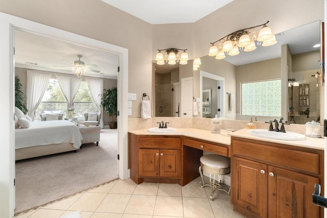 full bath with ensuite bathroom, a sink, a stall shower, and tile patterned floors