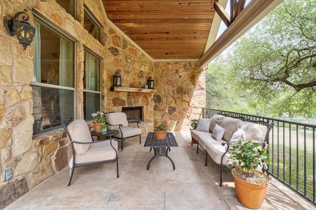 view of patio featuring an outdoor living space with a fireplace