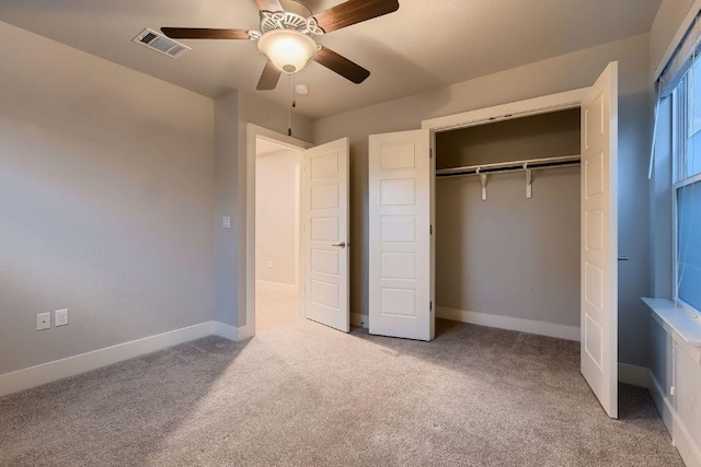 unfurnished bedroom featuring visible vents, carpet, baseboards, and a closet