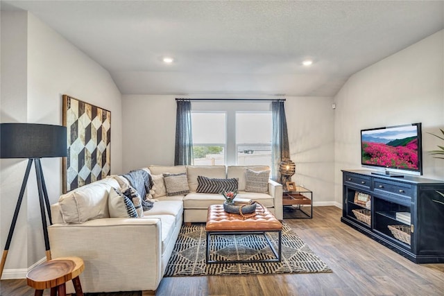 living room featuring wood finished floors, recessed lighting, baseboards, and lofted ceiling