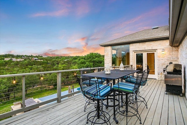 deck with french doors and a grill
