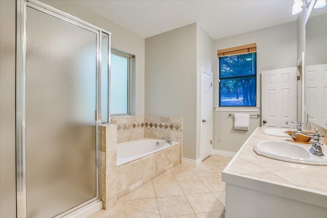 full bath with a sink, tile patterned flooring, a stall shower, and a bath
