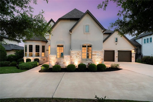 2033 Portobello Rd, Leander, TX 78641 - french country style house with stucco siding, stone siding, driveway, and a garage