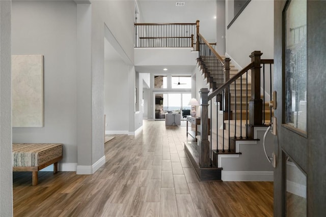 2033 Portobello Rd, Leander, TX 78641 - foyer entrance with stairway, a high ceiling, wood finished floors, and baseboards