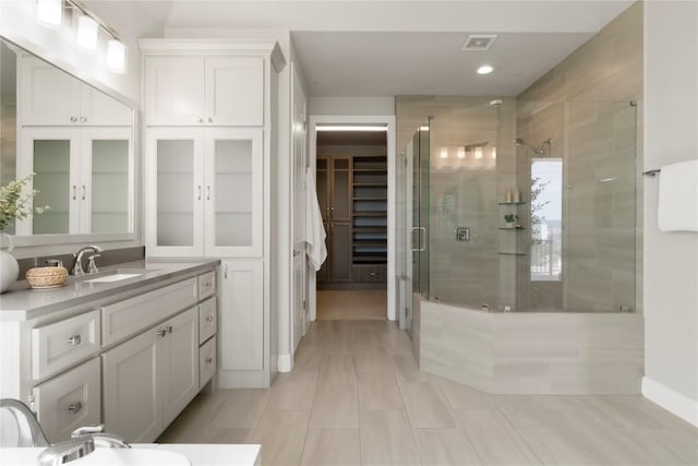 2033 Portobello Rd, Leander, TX 78641 - bathroom featuring a shower stall, vanity, a walk in closet, recessed lighting, and tile patterned floors