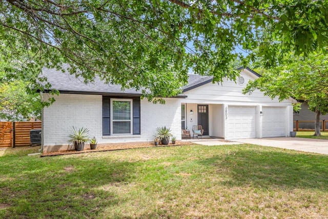 single story home with fence, a front lawn, brick siding, a garage, and driveway