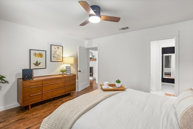 bedroom with visible vents, dark wood-style flooring, ceiling fan, and baseboards