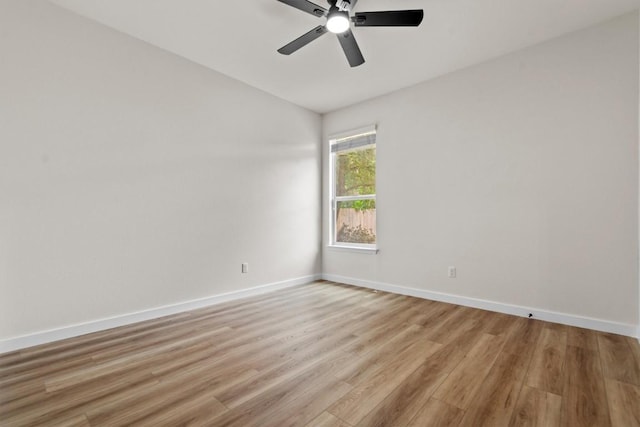 unfurnished room with light wood-style floors, baseboards, and ceiling fan