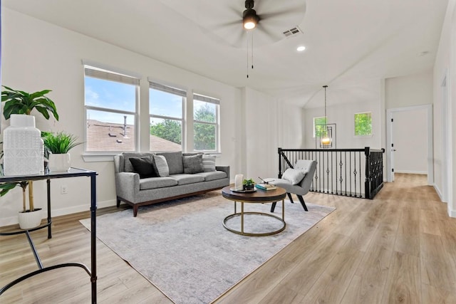 living area featuring light wood finished floors, a ceiling fan, baseboards, recessed lighting, and visible vents