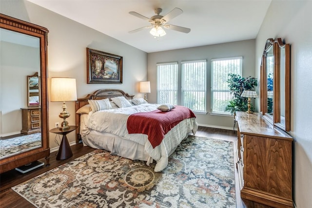 bedroom featuring baseboards, ceiling fan, and wood finished floors