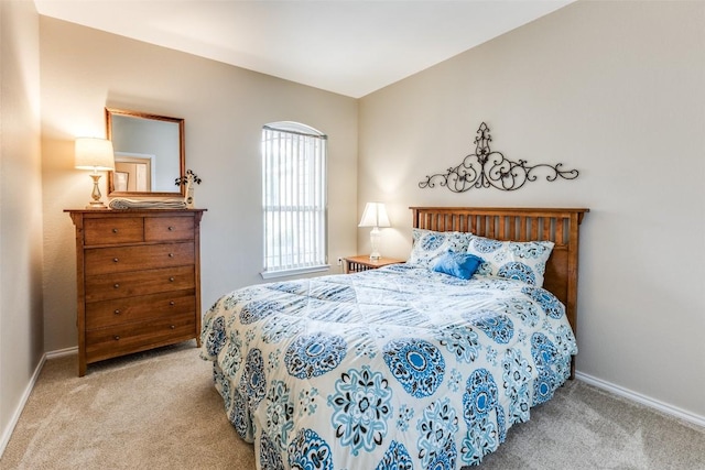 carpeted bedroom featuring baseboards