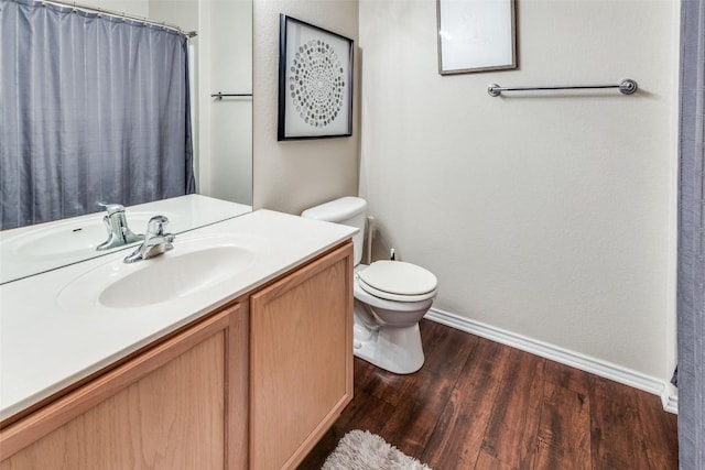 full bath featuring vanity, wood finished floors, toilet, baseboards, and a shower with shower curtain