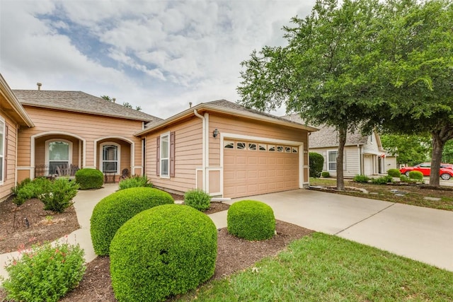 view of front of property featuring an attached garage and driveway