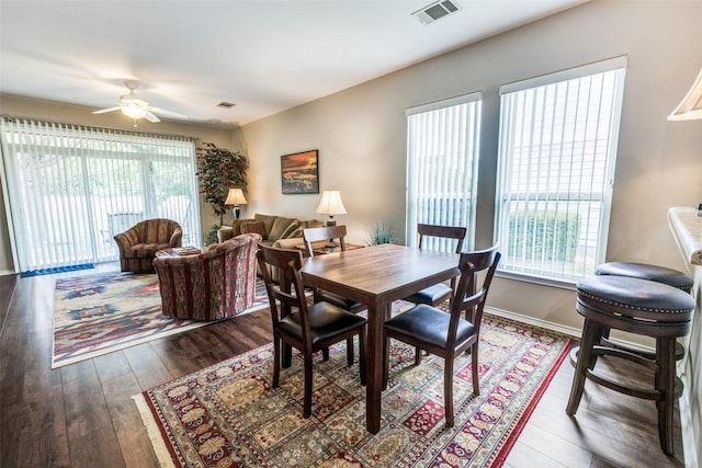 dining area featuring a ceiling fan, dark wood-style flooring, and visible vents