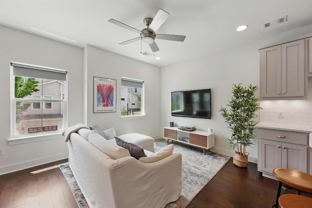 living room with recessed lighting, a ceiling fan, and dark wood-style flooring