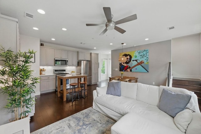 living area featuring recessed lighting, a ceiling fan, dark wood-style floors, and visible vents