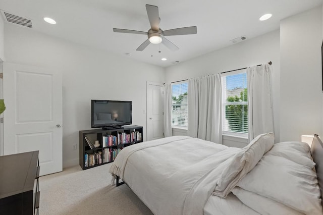 carpeted bedroom with a ceiling fan, recessed lighting, and visible vents