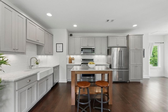 kitchen featuring a sink, appliances with stainless steel finishes, and gray cabinetry