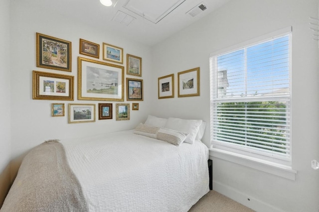 bedroom with visible vents, carpet floors, and multiple windows