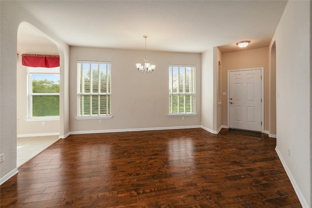 unfurnished dining area with an inviting chandelier, hardwood / wood-style flooring, and a healthy amount of sunlight