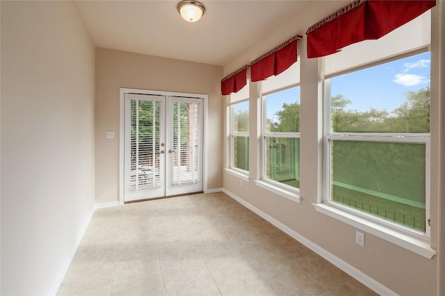 unfurnished sunroom featuring french doors