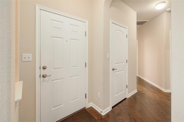 foyer with visible vents, dark wood finished floors, and baseboards