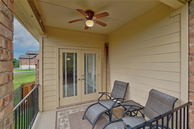 balcony with french doors and a ceiling fan