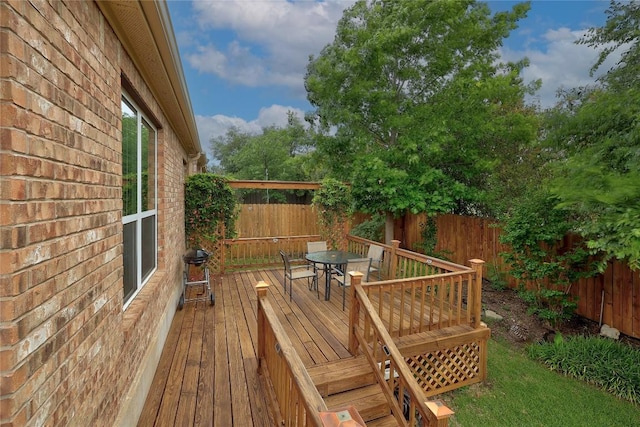deck featuring area for grilling, a fenced backyard, and outdoor dining space