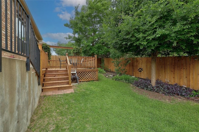 view of yard featuring stairs, a fenced backyard, and a deck