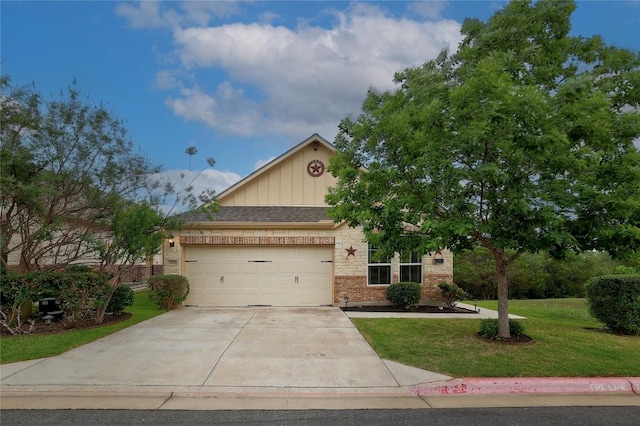 3451 Mayfield Ranch Blvd Unit 369, Round Rock, TX 78681 - view of front of home featuring board and batten siding, brick siding, a front yard, driveway, and a garage