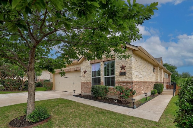 view of home's exterior with concrete driveway, a yard, stone siding, and a garage