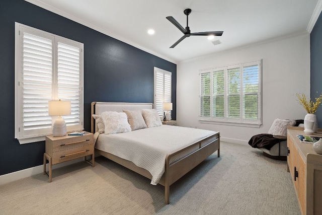 bedroom featuring crown molding, baseboards, and light colored carpet