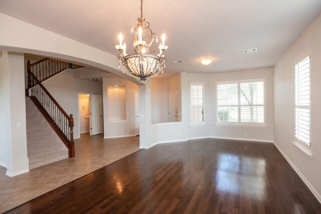 7901 SW Pkwy Unit 16, Austin, TX 78735 - unfurnished room featuring stairs, wood finished floors, arched walkways, and plenty of natural light